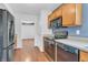 A functional kitchen featuring wood cabinetry, stainless steel appliances, and open access to other rooms at 6329 Whitaker Farms Dr, Indianapolis, IN 46237