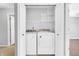 Convenient laundry room features a full-sized washer and dryer in a closet with built-in storage shelving at 6329 Whitaker Farms Dr, Indianapolis, IN 46237