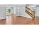 Bright living room with wood floors and staircase at 6329 Whitaker Farms Dr, Indianapolis, IN 46237