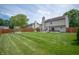 Large fenced backyard with healthy lawn and patio at 6562 Quail Run, Fishers, IN 46038