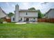 Expansive backyard featuring a spacious lawn and patio space at 6562 Quail Run, Fishers, IN 46038