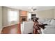 Bright living room with a brick fireplace, ceiling fan, wood floors, and comfortable sectional sofa at 6562 Quail Run, Fishers, IN 46038