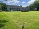 Expansive backyard with lush green grass and mature trees, perfect for outdoor gatherings and activities at 6932 Deerbrook Ct, Indianapolis, IN 46214