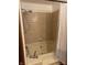 Standard bathroom with tub/shower featuring neutral brown patterned ceramic tile surround at 6932 Deerbrook Ct, Indianapolis, IN 46214