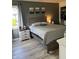 Comfortable bedroom with a bed, matching nightstand and dresser, and an organized closet at 6932 Deerbrook Ct, Indianapolis, IN 46214