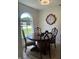 Elegant dining room with a large window, classic table and chairs, and a decorative clock on the wall at 6932 Deerbrook Ct, Indianapolis, IN 46214