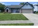 Charming one-story home with a well-manicured lawn, attached garage, and inviting front porch at 6932 Deerbrook Ct, Indianapolis, IN 46214
