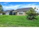 View of the backyard, showcasing the lawn and the house's rear exterior at 7205 Rose Hill Ave, Brownsburg, IN 46112