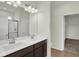 This luxurious bathroom features double sinks, a large mirror, and an entrance to a walk-in closet at 7205 Rose Hill Ave, Brownsburg, IN 46112