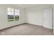 A carpeted bedroom features a bright window and is conveniently located next to the front door at 7205 Rose Hill Ave, Brownsburg, IN 46112