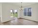Hardwood floor dining area features outdoor views, sliding door access, and stylish lighting at 7205 Rose Hill Ave, Brownsburg, IN 46112