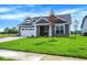 Beautiful home with well-kept lawn, lovely landscaping, and a cozy front porch at 7205 Rose Hill Ave, Brownsburg, IN 46112