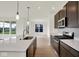 Modern kitchen with stainless steel appliances, large island, and an open layout at 7205 Rose Hill Ave, Brownsburg, IN 46112
