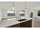 Bright and airy kitchen with an island, stainless steel sink, and an inviting view of the outdoors at 7205 Rose Hill Ave, Brownsburg, IN 46112