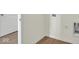The laundry room features wood floors, white walls and new hookups for washer and dryer at 7205 Rose Hill Ave, Brownsburg, IN 46112