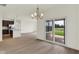 Bright living room with hardwood floors, access to the backyard, and an open view to the kitchen at 7205 Rose Hill Ave, Brownsburg, IN 46112
