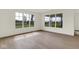 Bright living room with hardwood flooring and large windows overlooking green lawns at 7205 Rose Hill Ave, Brownsburg, IN 46112