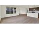 Bright living room with hardwood floors, connected to an open-concept kitchen and backyard views at 7205 Rose Hill Ave, Brownsburg, IN 46112