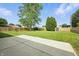 Spacious backyard featuring a concrete patio and lush lawn, framed by a wooden fence and mature trees at 7239 N Orchard Dr, Indianapolis, IN 46236