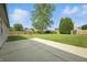 Large backyard featuring a lush lawn, mature trees, privacy fence, and a storage shed at 7239 N Orchard Dr, Indianapolis, IN 46236