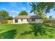 The home's backyard has a well-maintained lawn, wood fence, and small patio, perfect for enjoying outdoor living at 7239 N Orchard Dr, Indianapolis, IN 46236