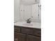 Bathroom with a vanity featuring dark cabinets, a marble countertop, and modern fixtures at 7239 N Orchard Dr, Indianapolis, IN 46236