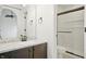 Bright bathroom featuring a modern vanity with marble countertops, a sleek black faucet, and a glass-enclosed shower at 7239 N Orchard Dr, Indianapolis, IN 46236