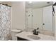 Bathroom featuring a modern toilet, patterned shower curtain, and a large mirror at 7239 N Orchard Dr, Indianapolis, IN 46236