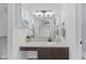 Bathroom featuring vanity, marble countertop, large mirror, and modern light fixture at 7239 N Orchard Dr, Indianapolis, IN 46236