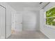Bright bedroom features fresh carpet and a sunlit window at 7239 N Orchard Dr, Indianapolis, IN 46236
