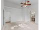 Bedroom with neutral paint, fan, carpet, and ensuite bathroom at 7239 N Orchard Dr, Indianapolis, IN 46236
