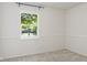 Bedroom featuring a window overlooking a lush backyard at 7239 N Orchard Dr, Indianapolis, IN 46236