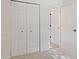 Bedroom features a closet with bi-fold doors and an open door to another room, offering ample storage at 7239 N Orchard Dr, Indianapolis, IN 46236
