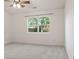 Bright bedroom with neutral walls, carpet and a window offering a view of the outdoors at 7239 N Orchard Dr, Indianapolis, IN 46236