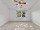 Bedroom with neutral paint, fan, carpet, and large window at 7239 N Orchard Dr, Indianapolis, IN 46236