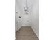 Front entryway features coat hooks, neutral paint, modern light fixture and vinyl flooring at 7239 N Orchard Dr, Indianapolis, IN 46236