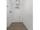 Bright foyer with hardwood floors, a modern light fixture, and a closet for storage at 7239 N Orchard Dr, Indianapolis, IN 46236