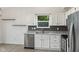 Modern kitchen featuring stainless appliances, granite counters and white cabinetry at 7239 N Orchard Dr, Indianapolis, IN 46236