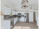 Modern kitchen with stainless steel appliances, granite countertops, white cabinets, and a stylish light fixture at 7239 N Orchard Dr, Indianapolis, IN 46236