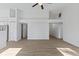 Open-concept living area features neutral paint, fan and modern vinyl plank flooring at 7239 N Orchard Dr, Indianapolis, IN 46236