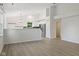 Open-concept living room with wood floors, vaulted ceilings, and modern light fixtures at 7239 N Orchard Dr, Indianapolis, IN 46236