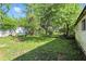 A spacious, green backyard featuring mature trees and a small fire pit at 7307 Twin Beech Dr, Indianapolis, IN 46226