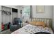 Bedroom features natural light, a brass bed frame, and a comfy reclining chair at 7307 Twin Beech Dr, Indianapolis, IN 46226