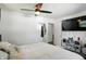 Serene bedroom featuring a spacious bed, ceiling fan, and ample natural light with a tidy minimalist decor at 7307 Twin Beech Dr, Indianapolis, IN 46226