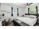 Inviting bedroom with neutral color palette, comfortable bed, plush pillows, and natural light from multiple windows at 7307 Twin Beech Dr, Indianapolis, IN 46226