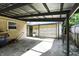Spacious carport offering shelter for vehicles or an outdoor workspace with access to the backyard at 7307 Twin Beech Dr, Indianapolis, IN 46226