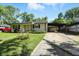 Exterior view showcasing the single-story home with covered parking and a well-kept front lawn at 7307 Twin Beech Dr, Indianapolis, IN 46226