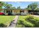 Charming single-story home with a well-maintained lawn, covered parking, and inviting front porch at 7307 Twin Beech Dr, Indianapolis, IN 46226