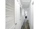 Bright hallway featuring white louvered doors and modern flooring, leading to other rooms at 7307 Twin Beech Dr, Indianapolis, IN 46226