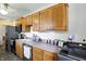 Efficient kitchen featuring wooden cabinets, stainless appliances, and combined space with laundry facilities at 7307 Twin Beech Dr, Indianapolis, IN 46226